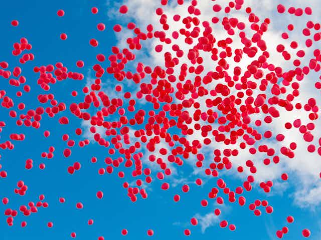 Lots of red balloons in the sky