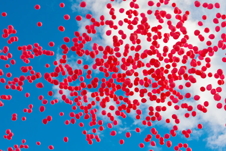 Lots of red balloons in the sky