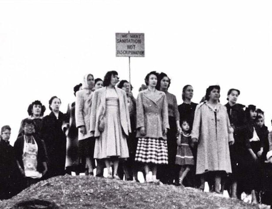 Women stand on a hill in solidarity.
