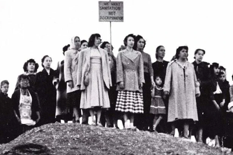 Women stand on a hill in solidarity.