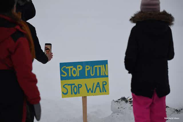A sign reads 'Stop Putin, Stop War'