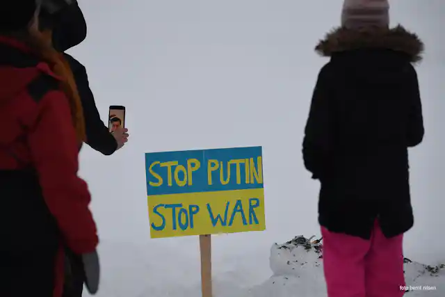 A sign reads 'Stop Putin, Stop War'