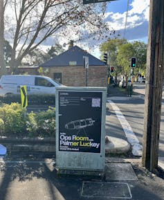 A poster promoting Luckey's talk is posted on a street box in inner Sydney.