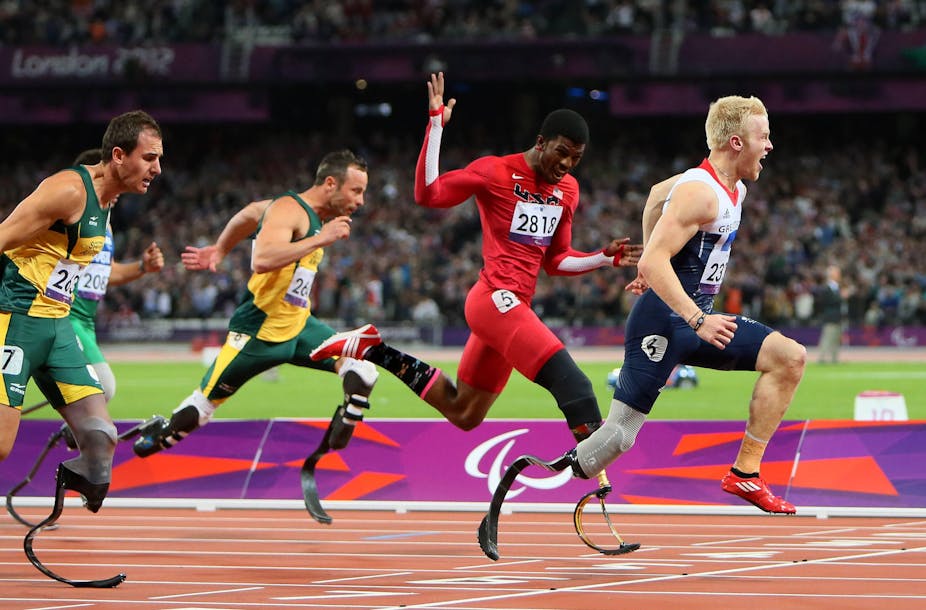 A group of four paralympians race over the finish line at the London 2012 Paralympics.