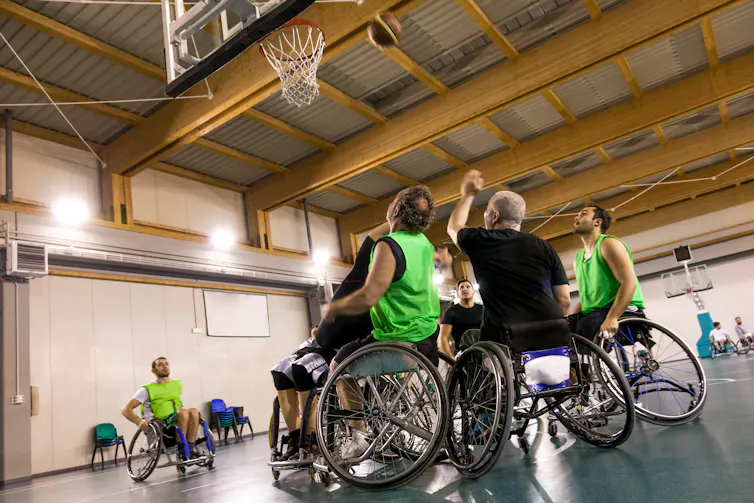 A group of men playing wheelchair rugby.