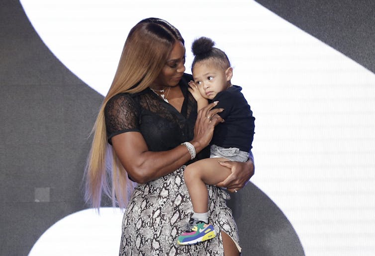 Serena Williams holding her daughter.