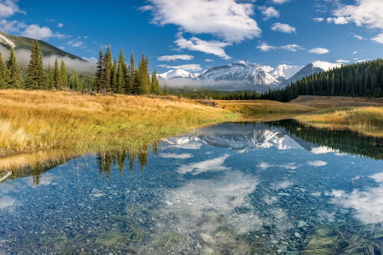 A lake with a mountain reflected in it