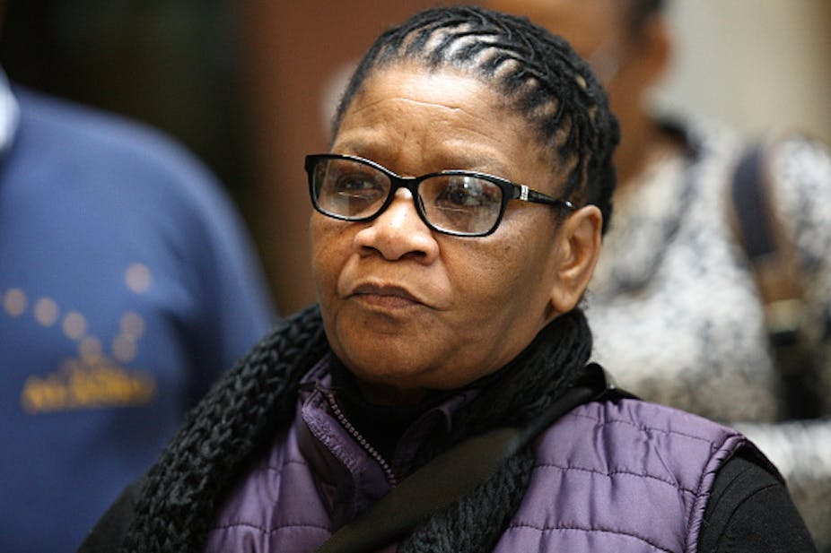A head-and-shoulders portrait of a woman with plaited dreadlocks who's wearing spectacles. She's South Africa's current defence minister, Thandi Modise.  