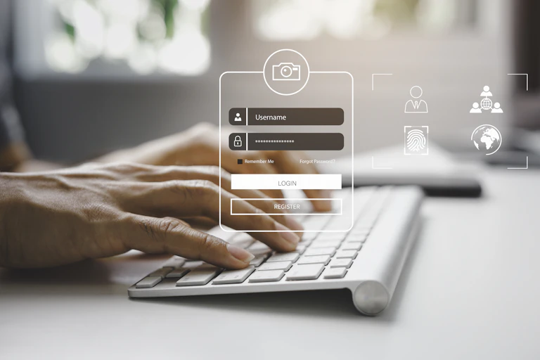 a representation of a login screen superimposed over a pair of hands type on a computer keyboard