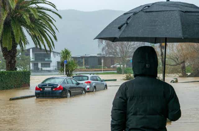 Person watching the flooding in Nelson in August 2022