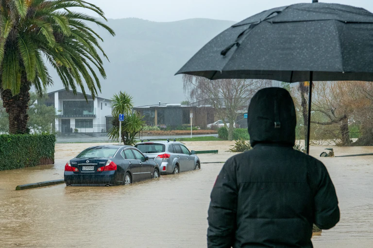 Person watching the flooding in Nelson in August 2022