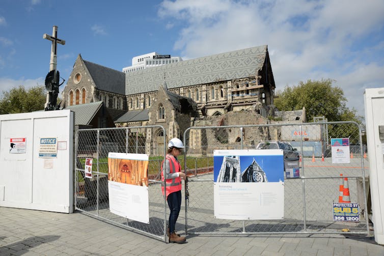 An engineer entering the construction site around the Christchurch cathedral.