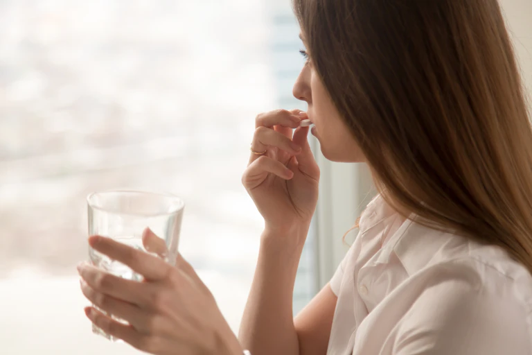 Woman taking a pill