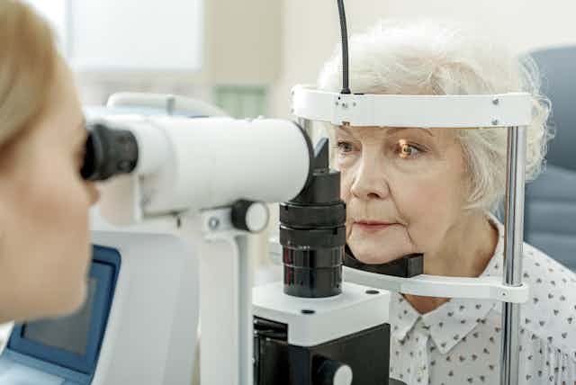 Elderly woman having her eyes examined