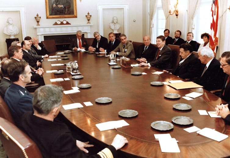Politicians sitting around an oval table