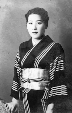 Woman in black and white picture wearing a Kimono.