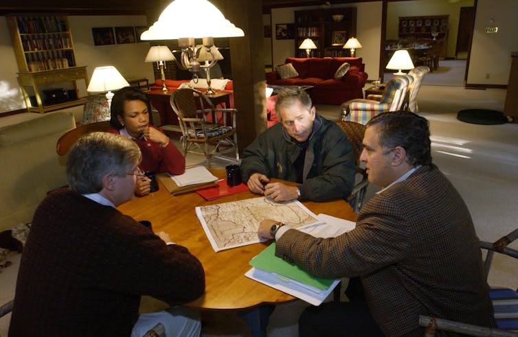 Politicians in discussion around a desk