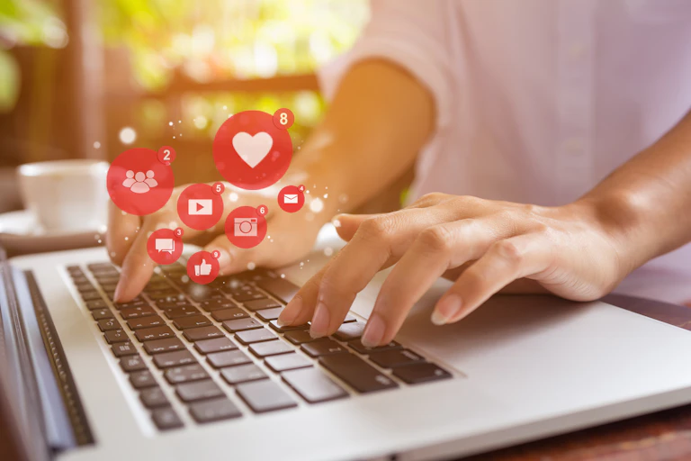 Laptop typing hands social media interaction symbols like share message photo