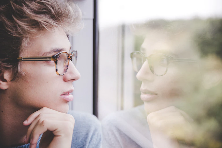 man looks at his reflection