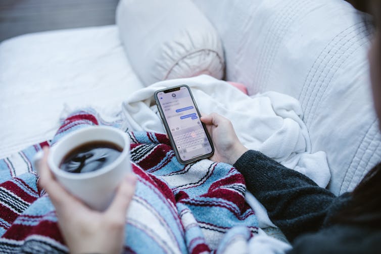 person holds phone with break up messages