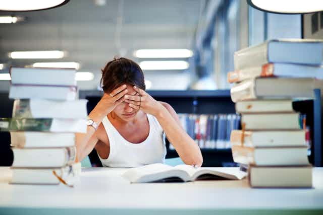 Woman looking stressed in library