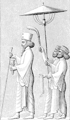 Line drawing of royal bearded man followed by two small men with umbrella and fly whisk.