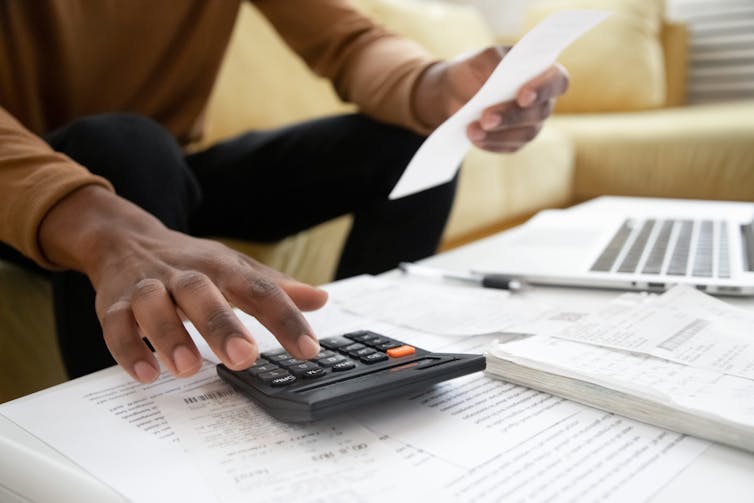 Photo of hands over calculator and documents