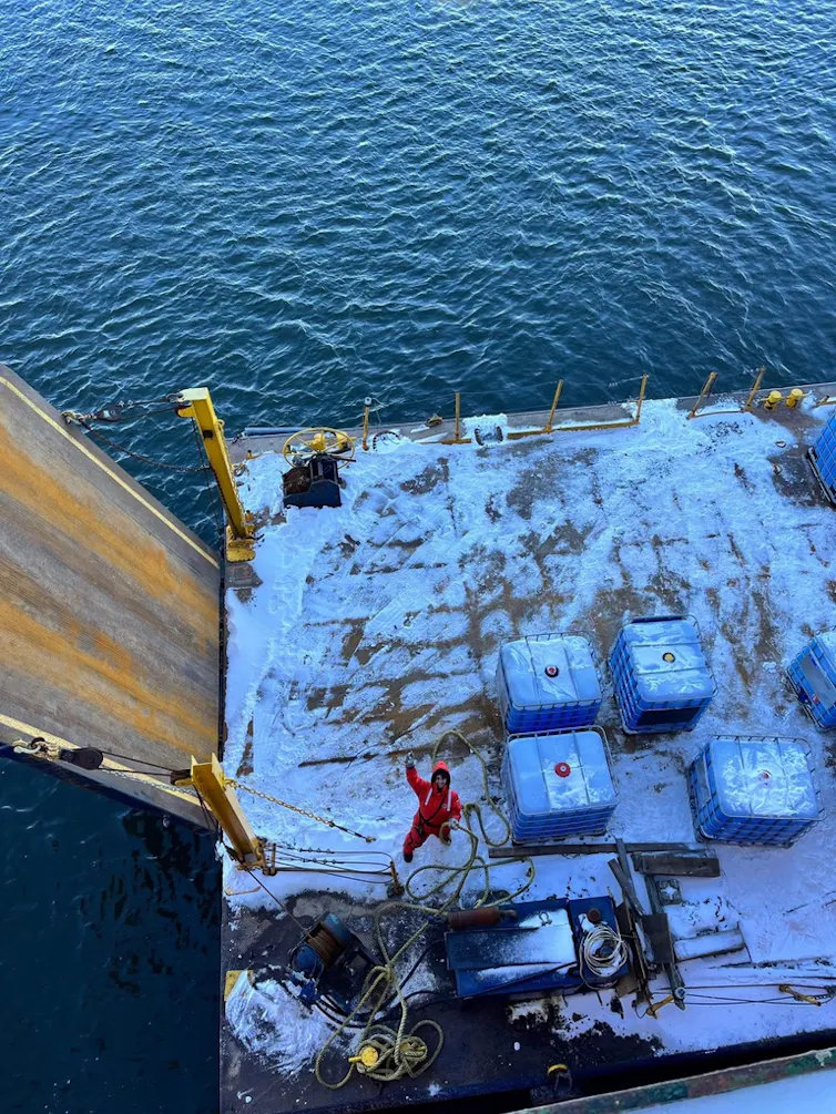 person on a barge seen from above in winter