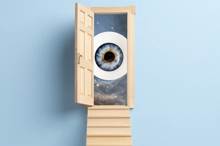 Illustration of steps leading up to open door with large eyeball on the other side