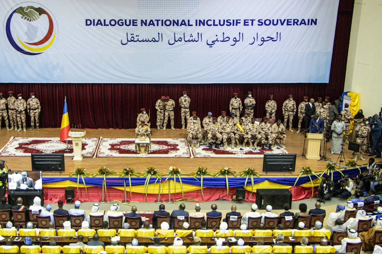 A group of people sitting in a large hall.