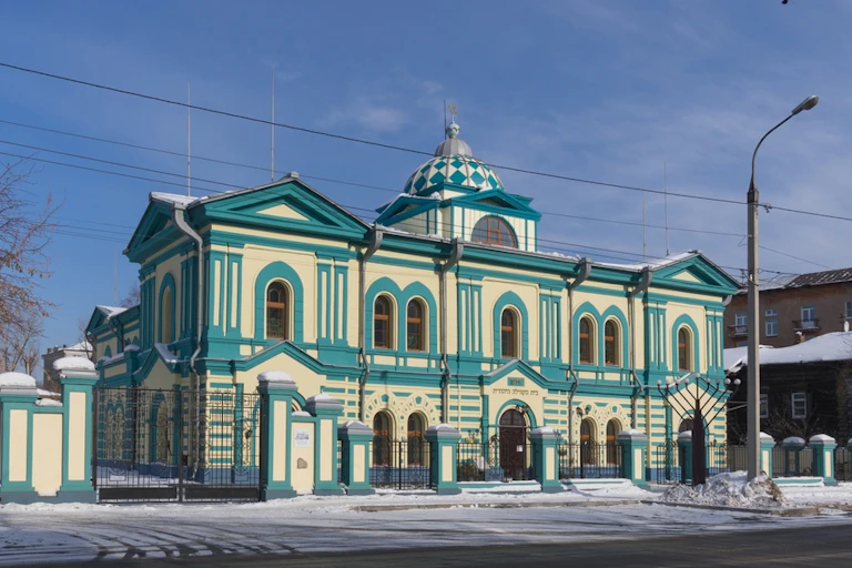 A green and white building.