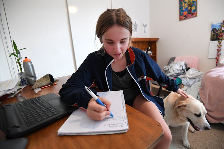 A student works at home during lockdowns in May 2020. Now there is an option with an online only private school