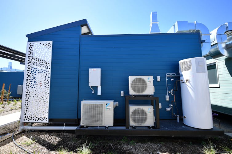 Blue cabin with three A/C units on outside