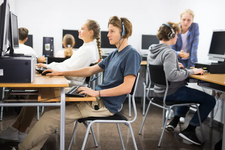 Students wearing headphones at computers