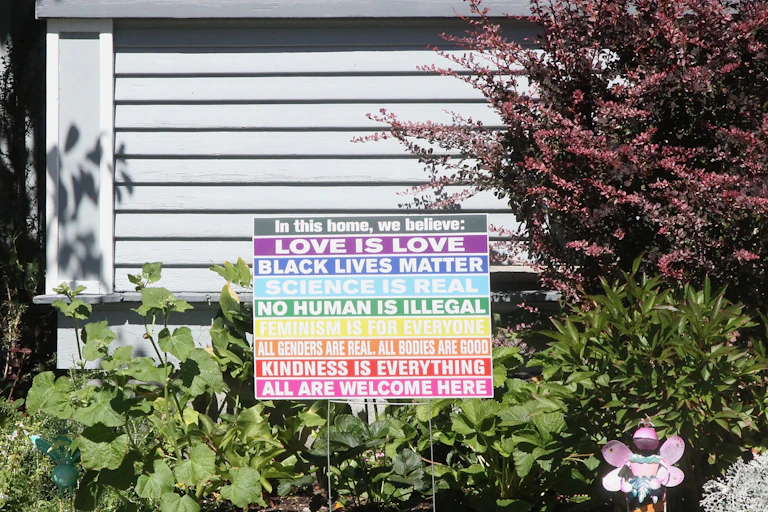 A sign listing eight virtues, including Black Lives Matter and No Human is Illegal.