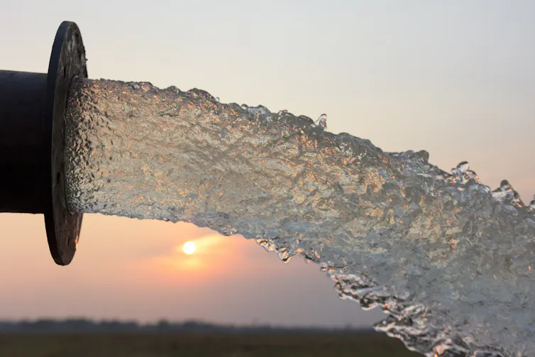 Water pouring out of pipe.