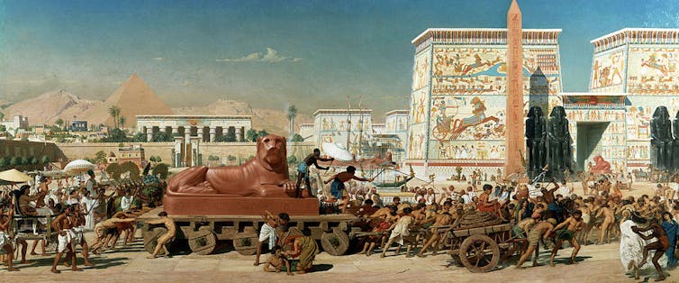 A painting shows men pulling a wagon with a heavy statue of a lion.