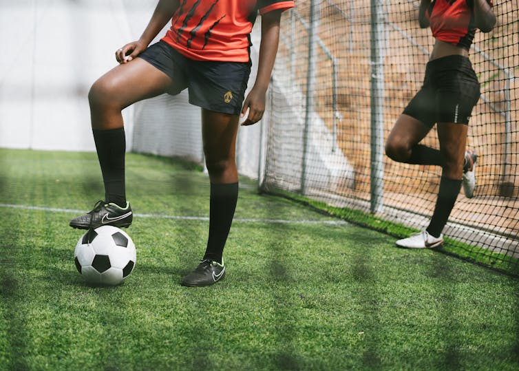 Soccer ball on grass being kicked