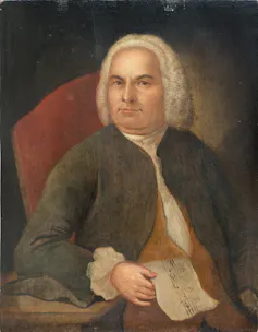 Pintura de Johann Sebastian Bach con una partitura en la mano.