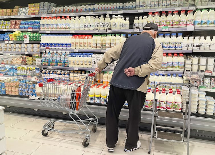 Man shopping, milk, trolley