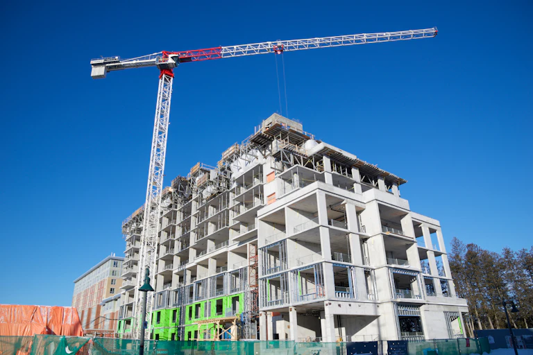 A crane stands over a building that is under construction