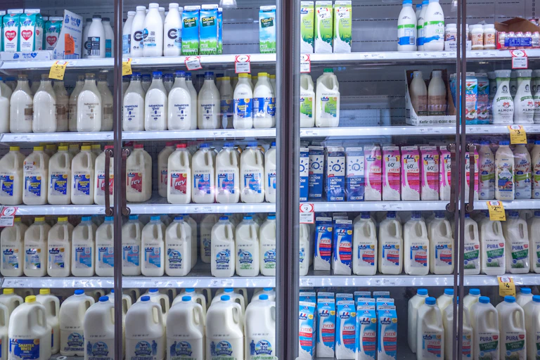 bottles of milk in fridge at supermarket