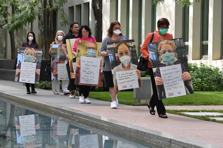 A delegation of workers from the aged care sector arrive for a press conference at Parliament House in Canberra, Thursday, February 10, 2022.