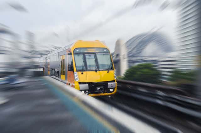 Train with blurred Sydney background