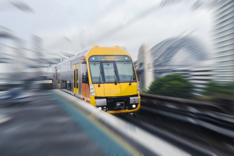 Train with blurred Sydney background