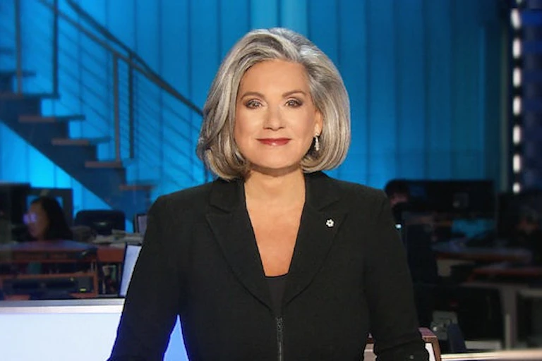 Lisa Laflamme sits behind a newsdesk.