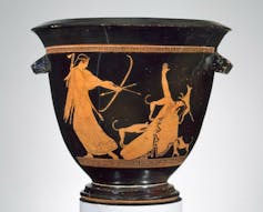 A black vase from 470 B.C. showing two figures, one turning toward a hunter to shoot him with her bow.