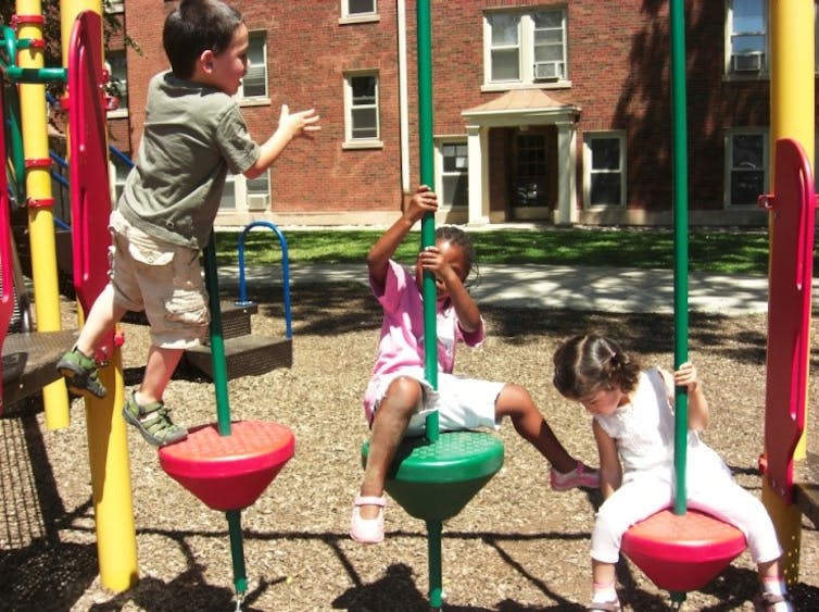 Children look at the structure of toys.