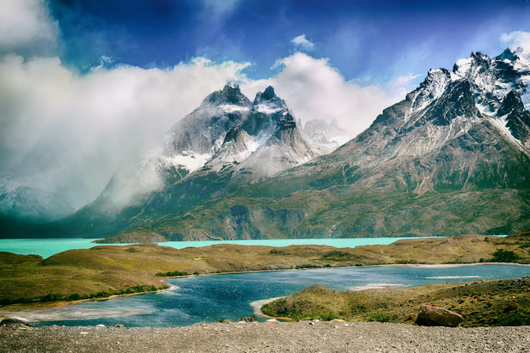 Snow-capped mountains behind a river