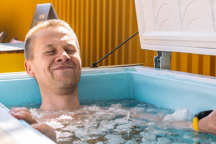 A man sits in an ice bath.